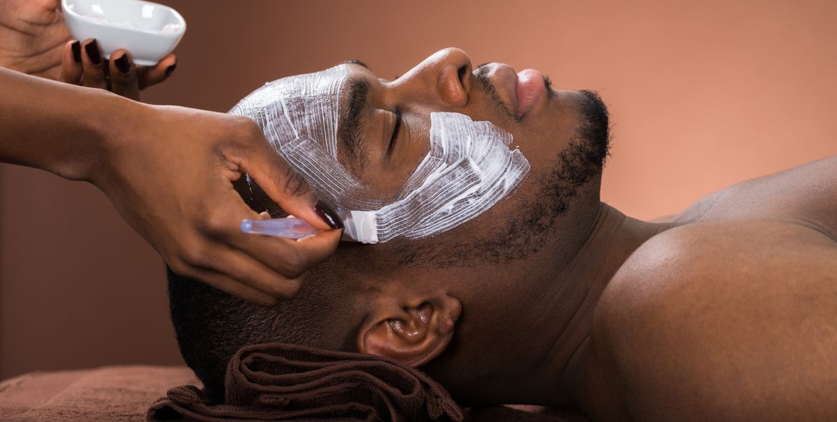 therapist-applying-face-mask-to-man-royalty-free-image-609094134-1547225313